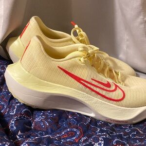 Nike yellow and red. Brand new, great running and walking shoes.